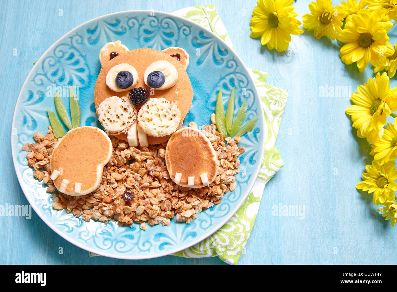 Beaver shaped pancakes with berries and granola Stock Photo
