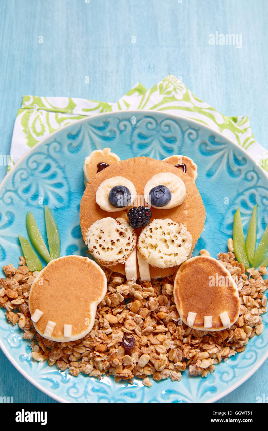 Beaver shaped pancakes with berries and granola Stock Photo