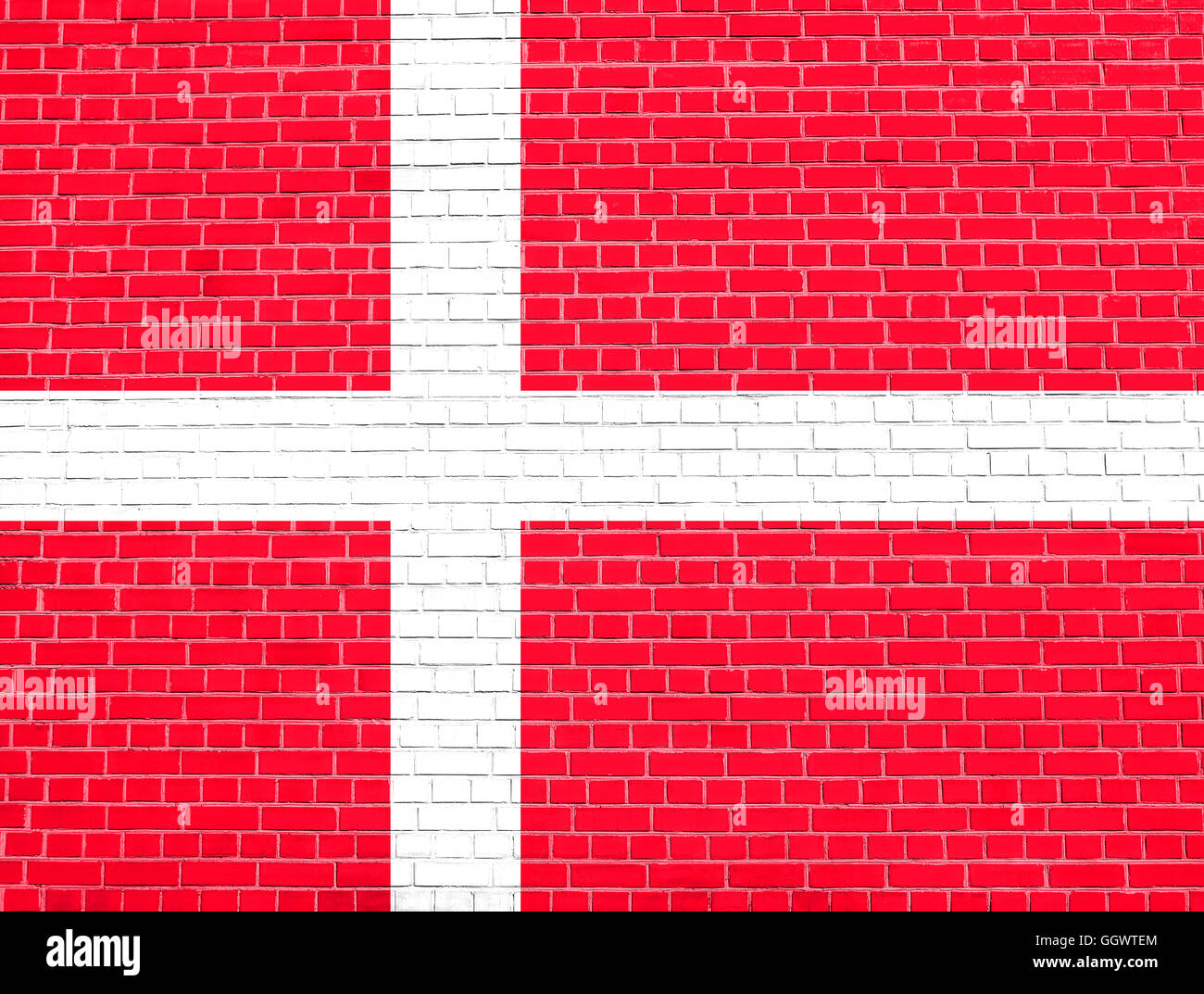 Flag of Denmark on brick wall texture background. Danish national flag. Stock Photo