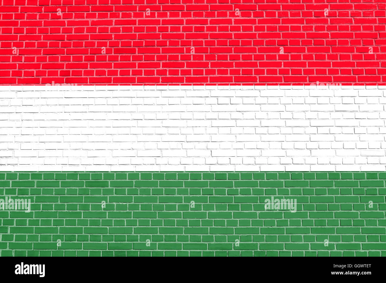 Flag of Hungary on brick wall texture background. Hungarian national flag. Stock Photo