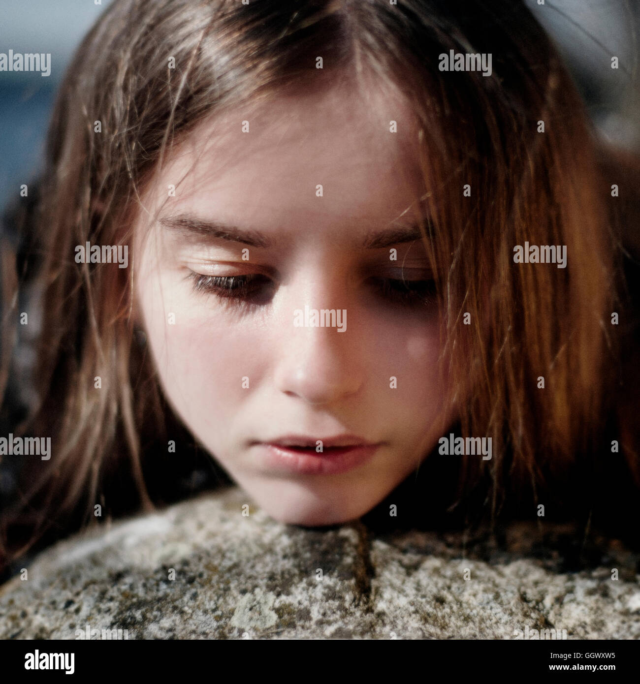 Face of pensive Caucasian girl outdoors Stock Photo