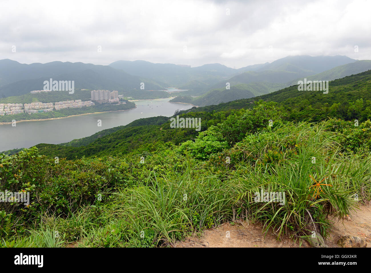 Green Tropical mountains and hiking route on the Dragon's Back trail near Hong Kong Stock Photo