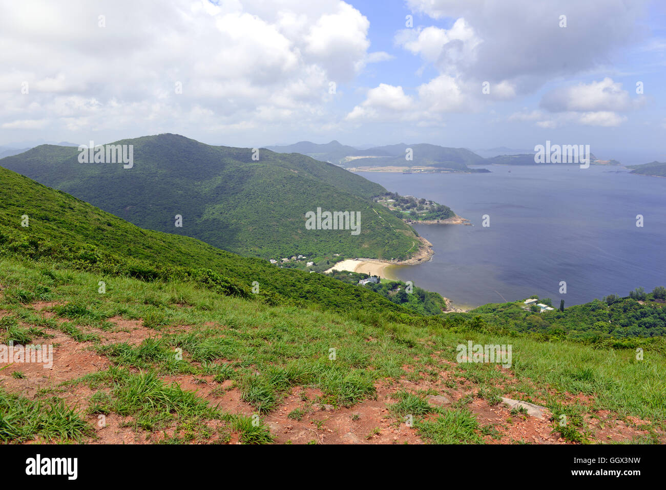 Green Tropical mountains and hiking route on the Dragon's Back trail near Hong Kong Stock Photo
