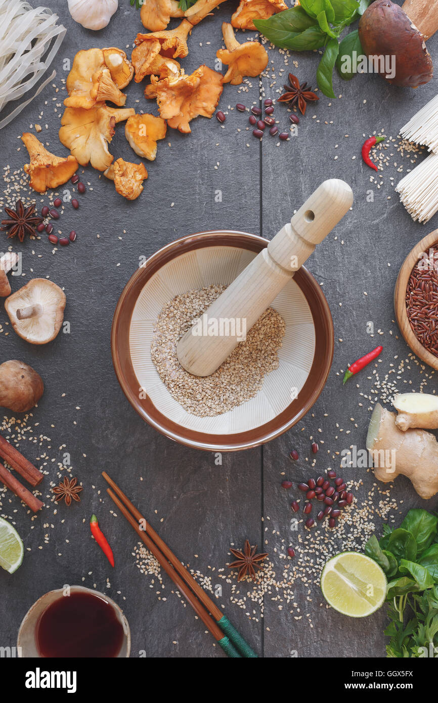 Asian still life. Japanese mortar ( suribachi and surikogi) and some of ingredients for cooking, top view Stock Photo