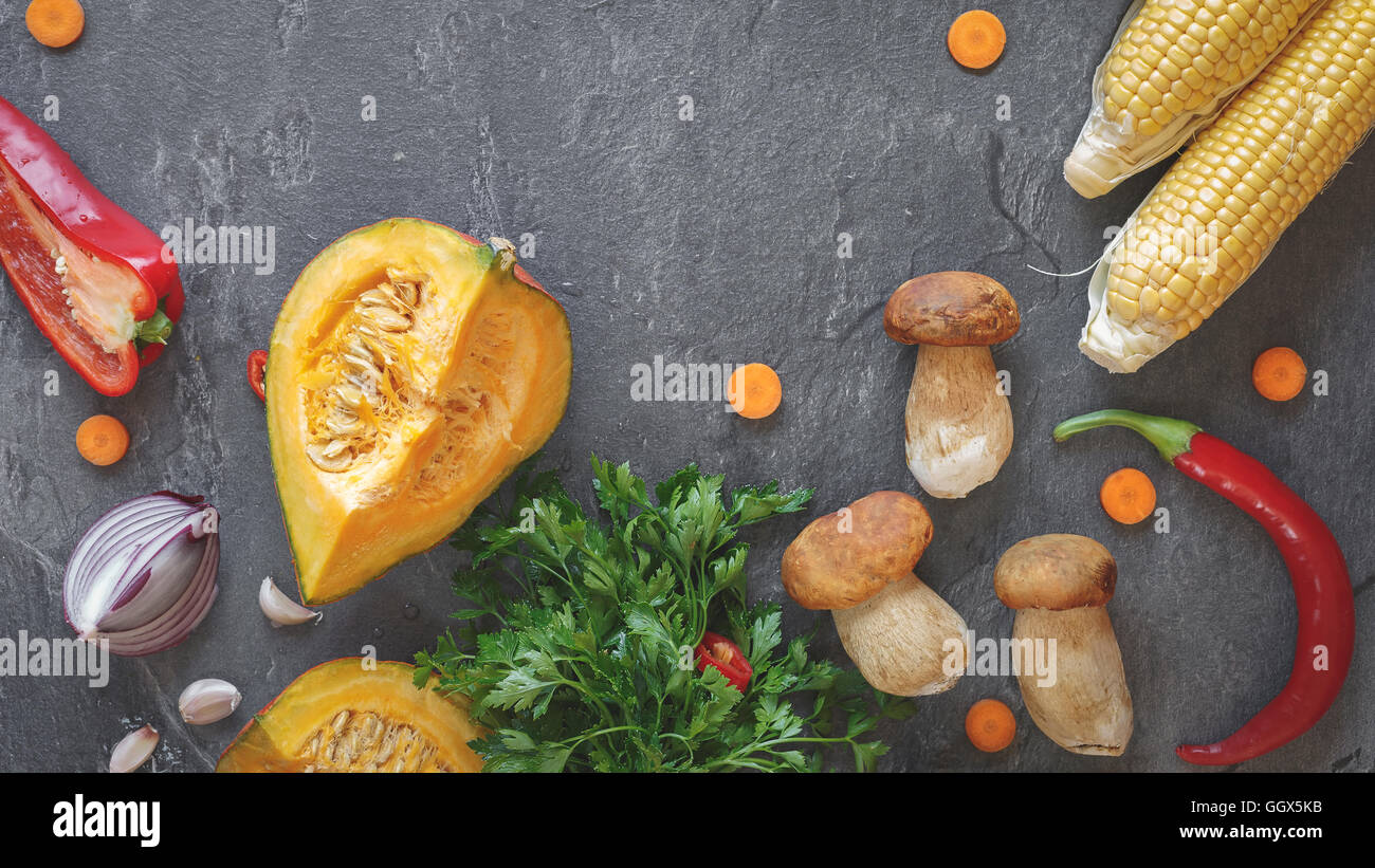Culinary background with fresh autumnal vegetables and mushrooms. Top view, vintage toned image, blank space Stock Photo