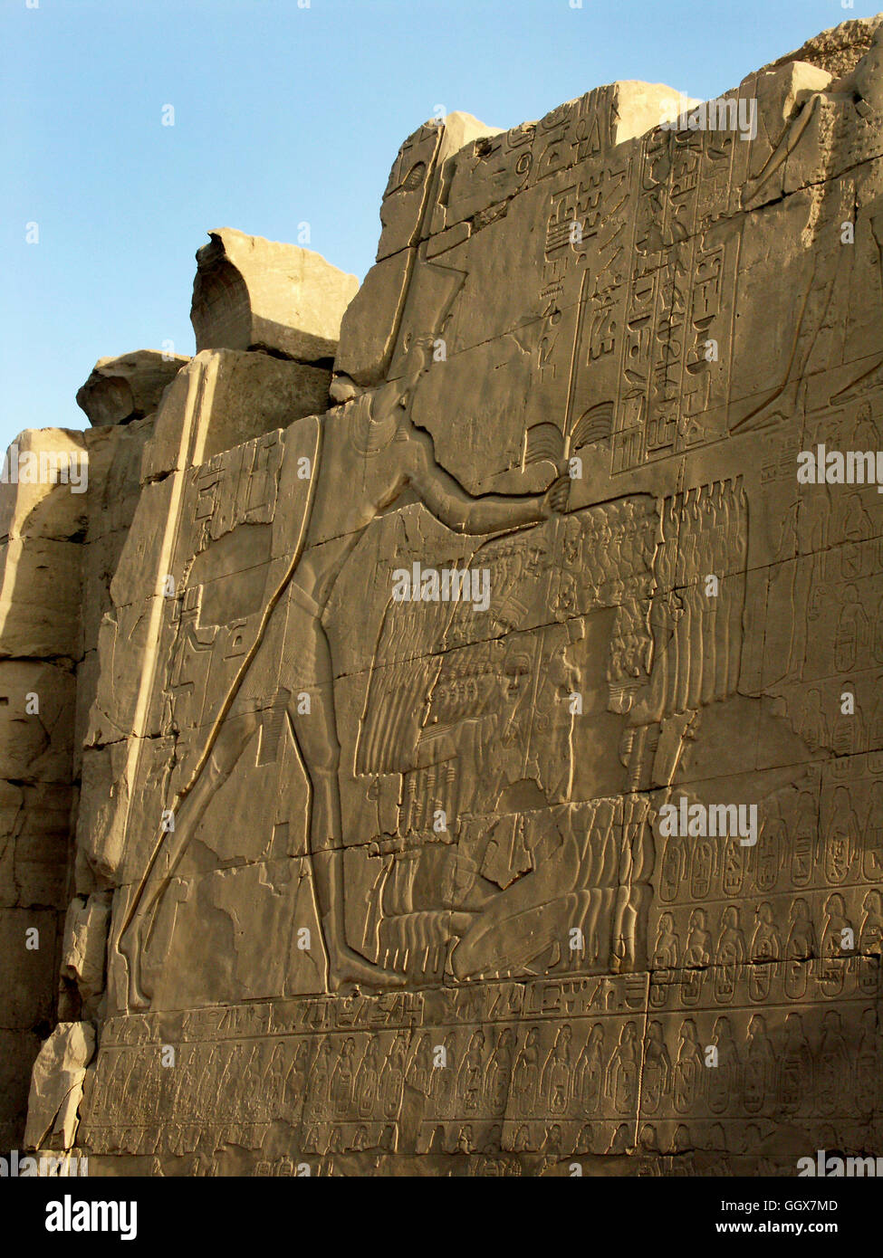 Wall relief of pharaoh Ramesis IV smiting enemies in the courtyard of the Temple of Karnak at Luxor – Egypt. Stock Photo