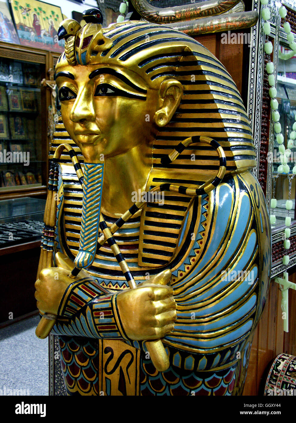 Store in the Coptic neighborhood of Cairo selling furniture modeled after ancient Egyptian artifacts. Mummy case of Tutankhamon. Stock Photo