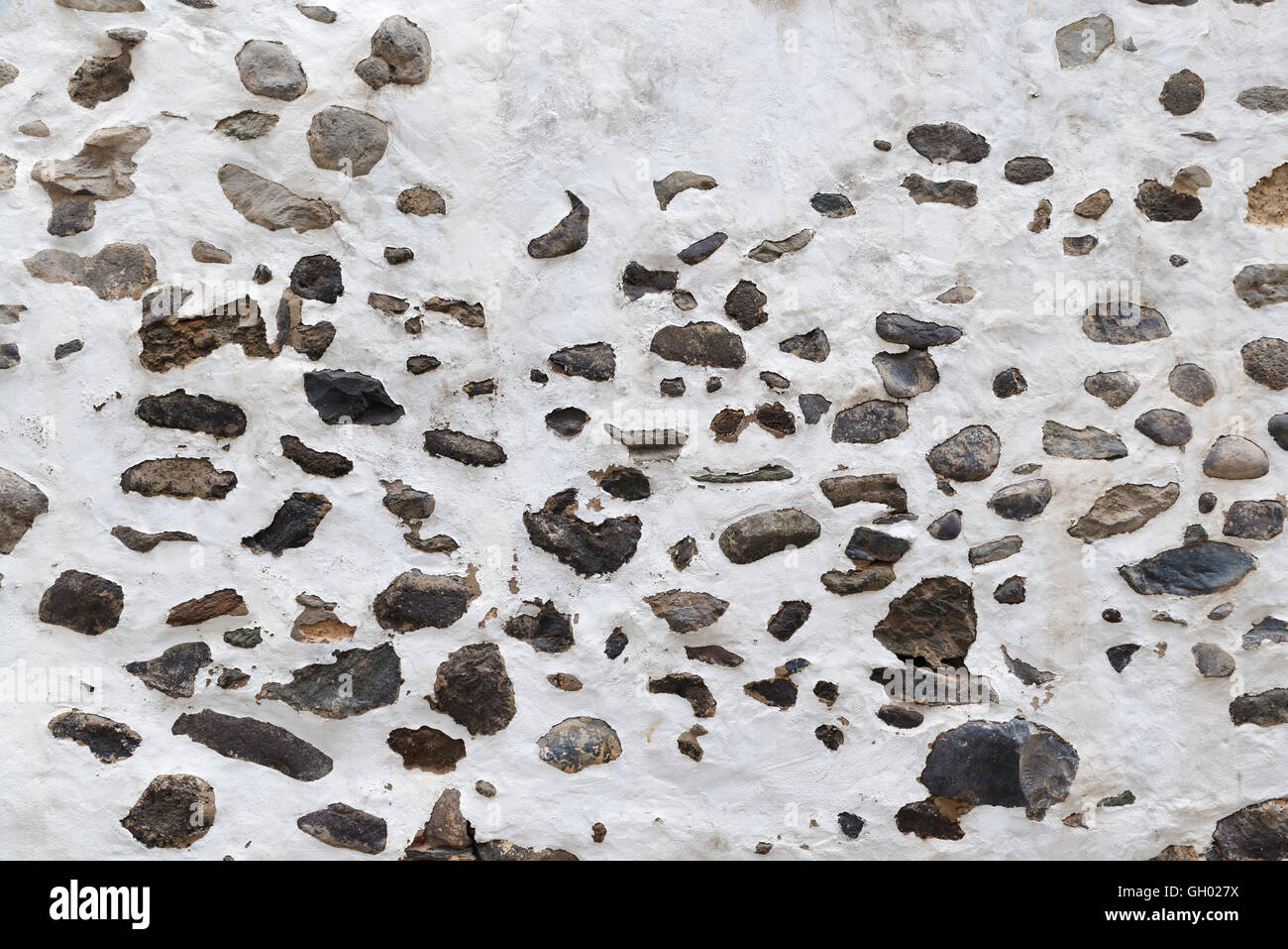 Background of damaged lime-wall with stones Stock Photo
