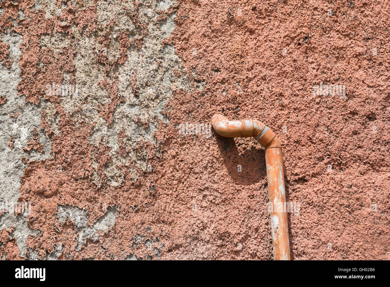 pipe in an old and rough wall Stock Photo