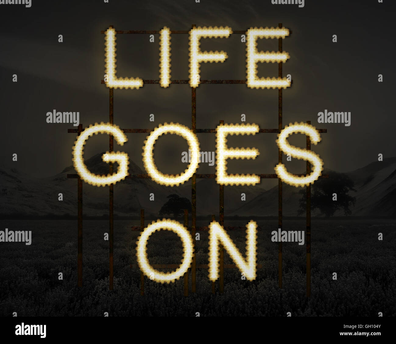 Life Goes On Inspirational Text In Lights Against Dark Landscape Stock Photo Alamy
