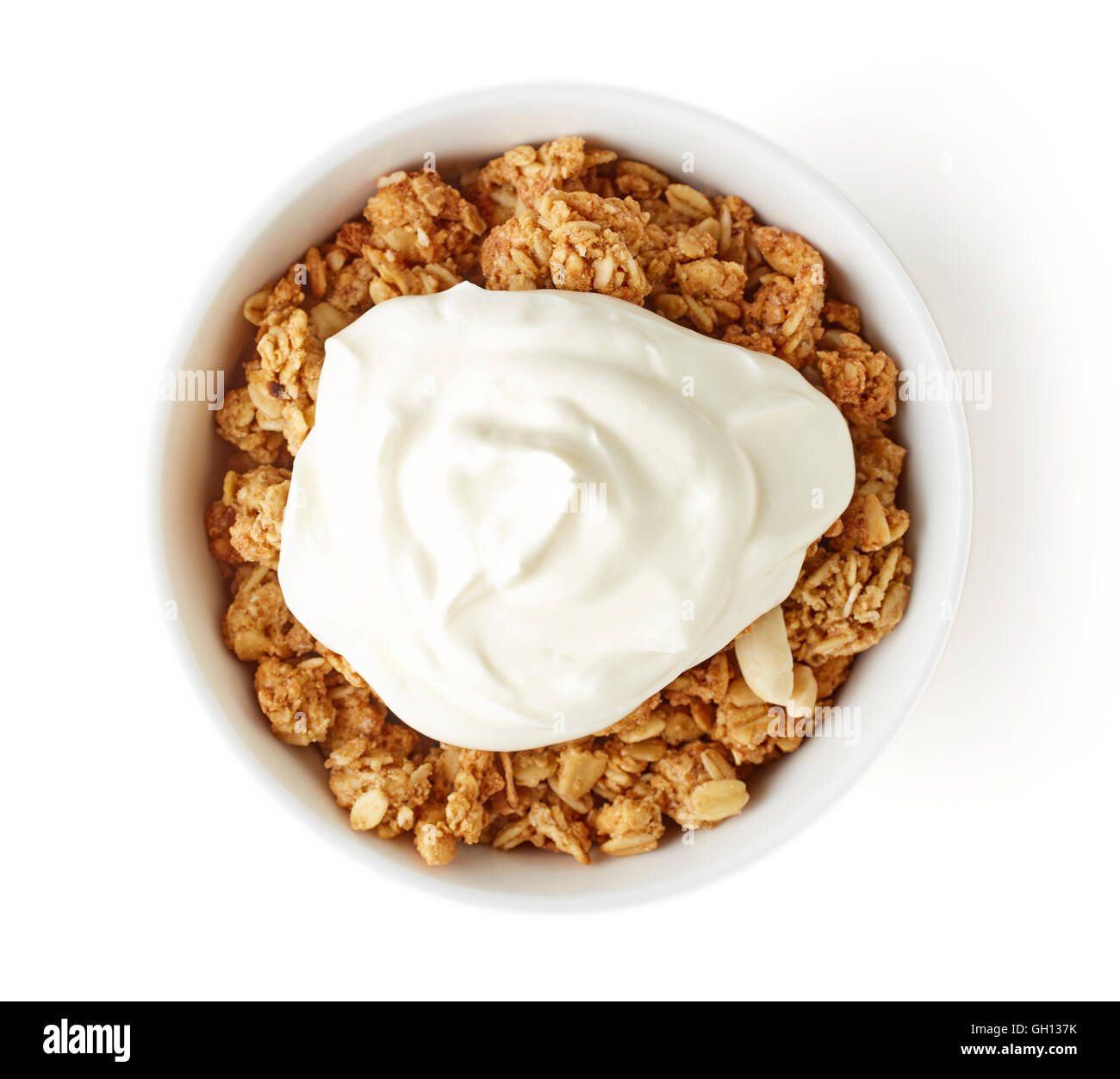 Bowl of whole grain muesli and yogurt isolated on white background, top view Stock Photo