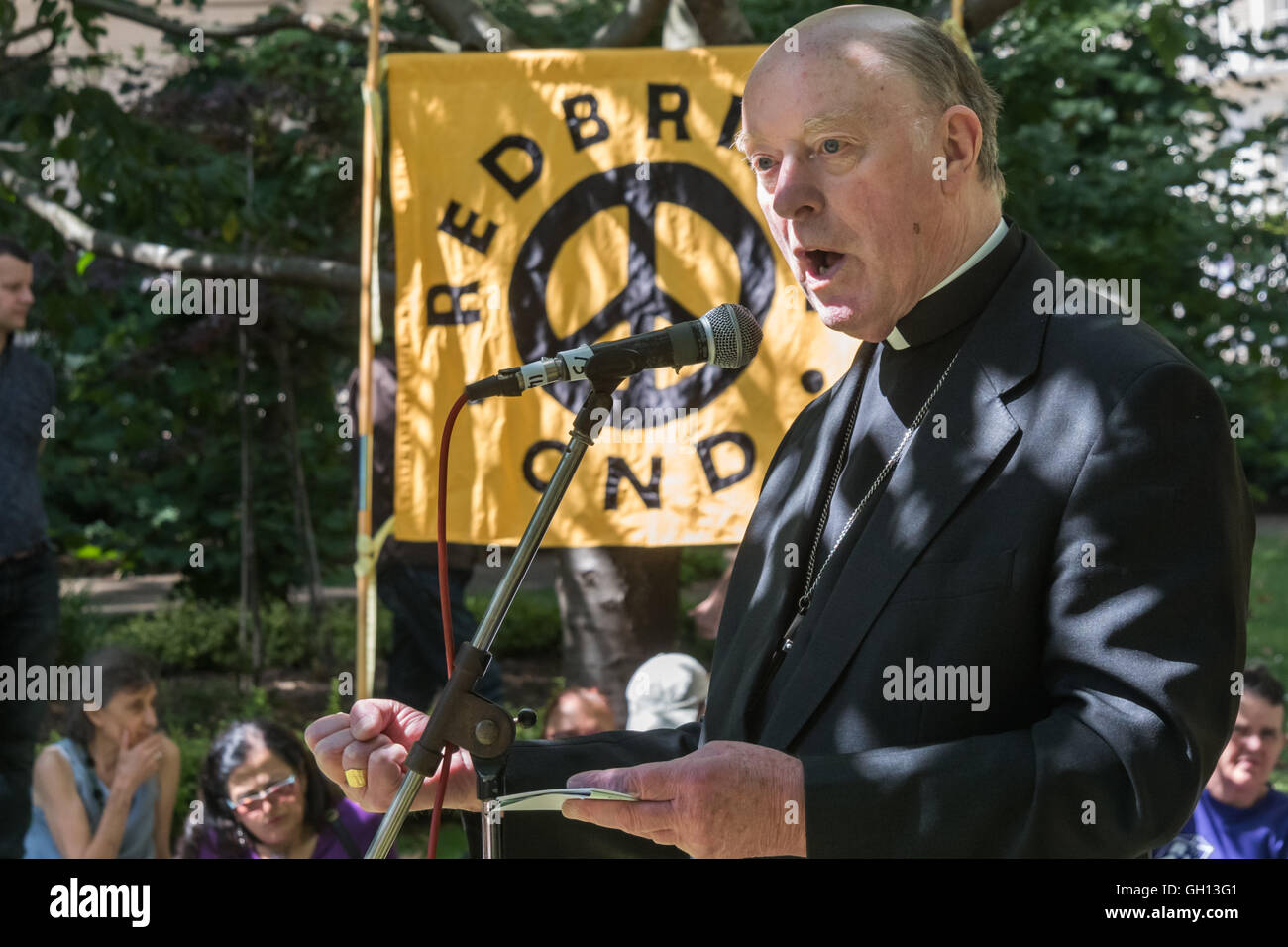 London, UK. 6th August 2016. Rt Rev Thomas McMahon, Bishop emeritus of Brentwood speaks at London CND ceremony in memory of the victims, past and present on the 71st anniversary of the dropping of the atomic bomb on Hiroshima and the second atomic bomb dropped on Nagasaki three days later. After a number of speeches and performances there was a two minute's silence during which the Mayor of Camden and others laid flowers around the commemorative cherry tree. Peter Marshall/Alamy Live News Stock Photo