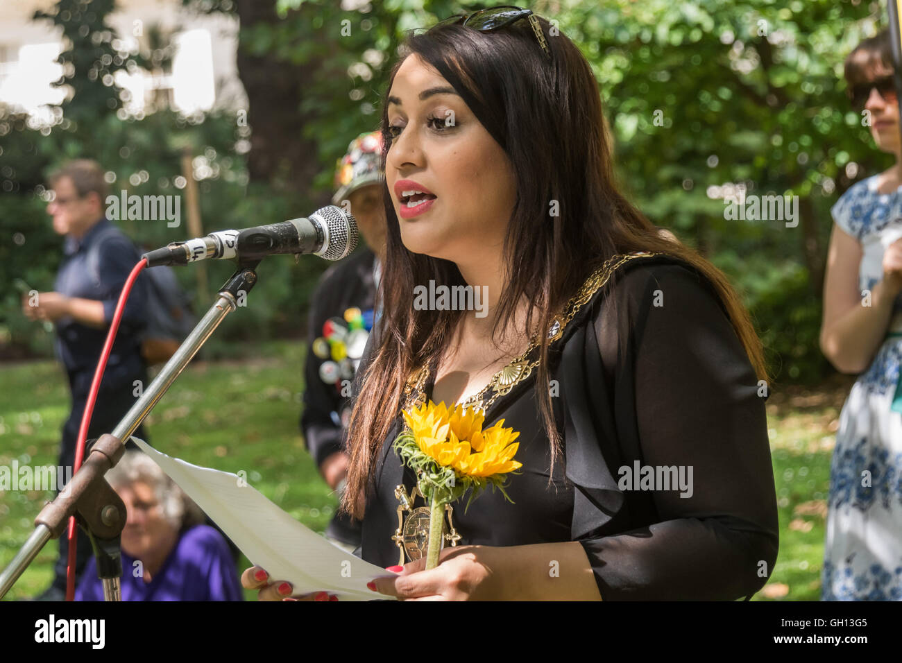 London, UK. 6th August 2016. Cllr Nadia Shah, Mayor of Camden, speaks at London CND  ceremony in memory of the victims, past and present on the 71st anniversary of the dropping of the atomic bomb on Hiroshima and the second atomic bomb dropped on Nagasaki three days later. After a number of speeches and performances there was a two minute's silence during which the Mayor of Camden and others laid flowers around the commemorative cherry tree. Peter Marshall/Alamy Live News Stock Photo
