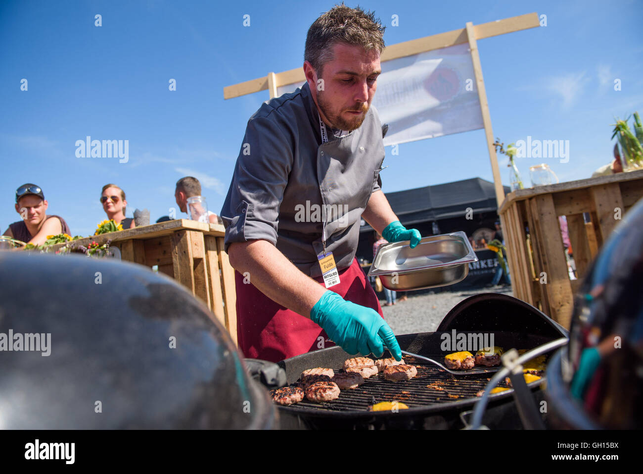 Fulda, Germany. 07th Aug, 2016. Daniel Schaefer from Team Aartal-BBQ-Crew  grills a meal during the 21st German BBQ Championships in Fulda, Germany,  07 August 2016. Around 40 teams will be grilling in