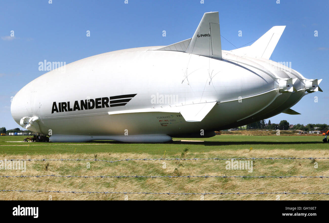 Cardington, Bedfordshire, UK. 07th Aug, 2016. The world's largest aircraft was brought out of its hangar for the first time this weekend The plane/airship hybrid, Airlander 10, was moved out of the UK's biggest hangar at Cardington, Bedfordshire. The 302ft-long (92m) aircraft was towed to its mast site on fields within the Hybrid Air Vehicles complex, thus giving the £25 million its public debut. Date of it's maiden flight - orginally hoped to have been at the recent Farnborough Air Show - has still to be announced. August 7th 2016   Credit:  KEITH MAYHEW/Alamy Live News Stock Photo