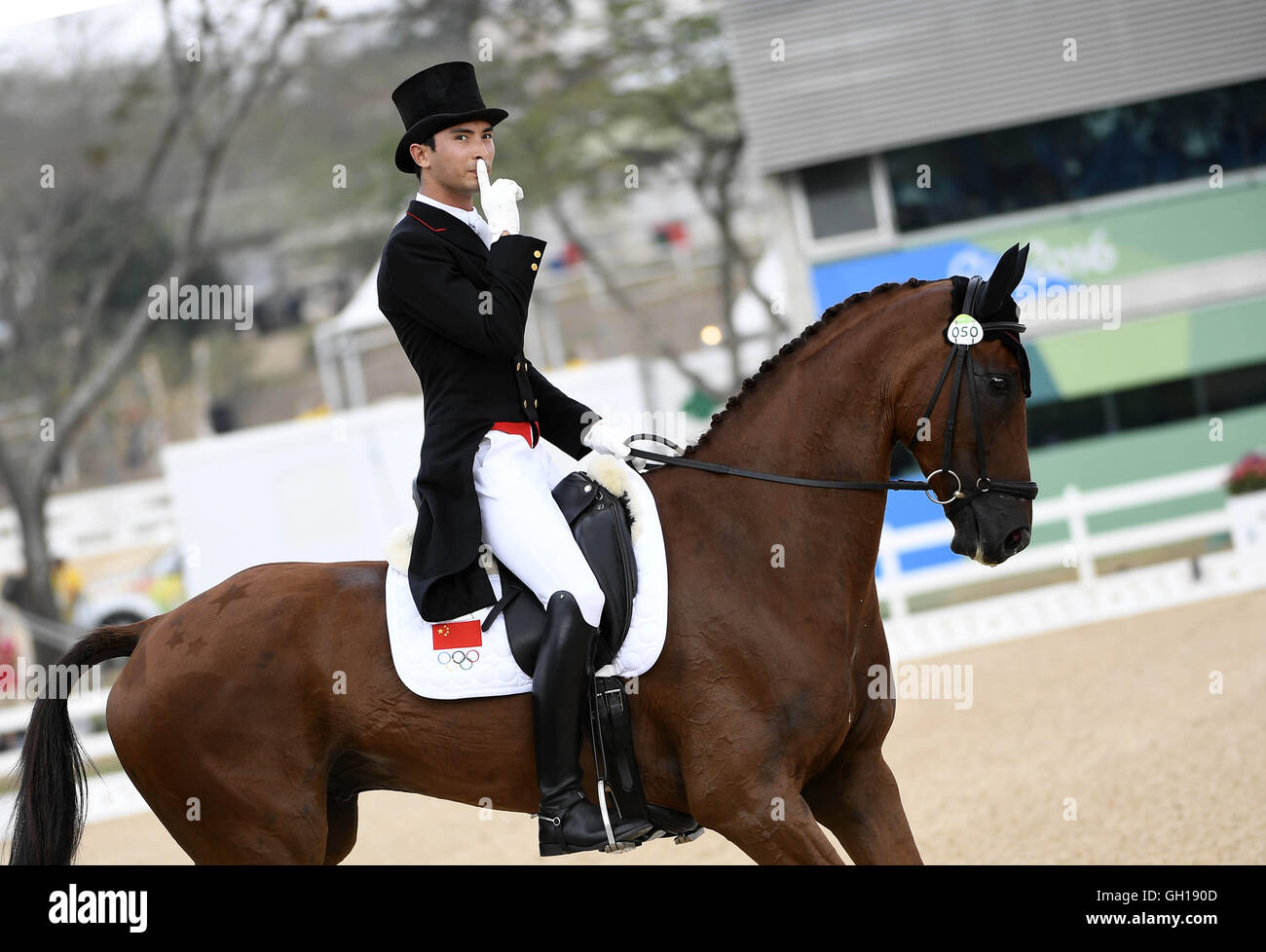 Rio de Janeiro, Brazil. 07th Aug, 2016. Hua Tian of China and his horse Don Geniro react after the eventing individual dressage competition of equestrian at the 2016 Rio Olympic Games in Rio de Janeiro, Brazil, on Aug. 7, 2016. Credit:  Xinhua/Alamy Live News Stock Photo