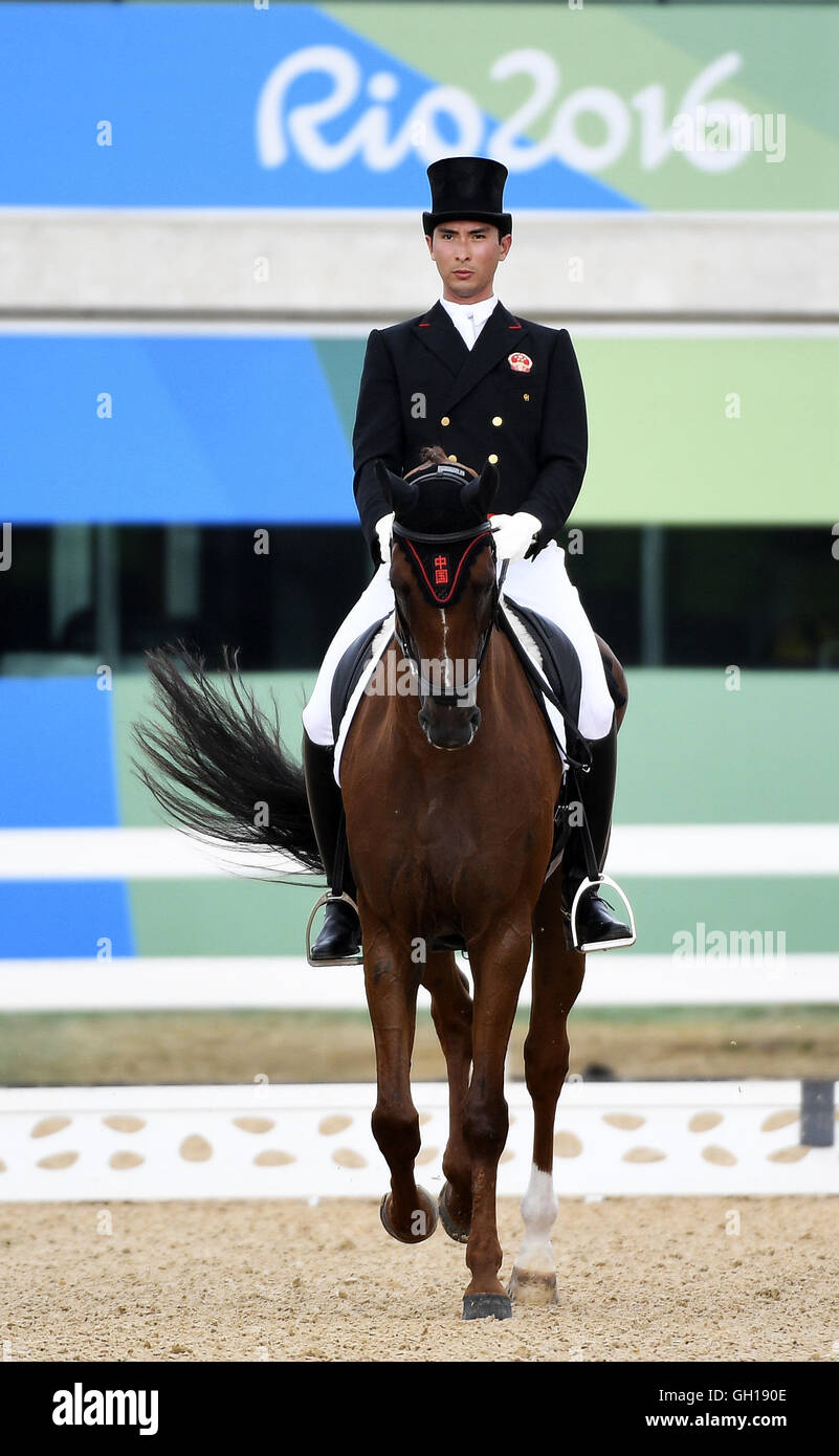 Rio de Janeiro, Brazil. 07th Aug, 2016. Hua Tian of China and his horse Don Geniro compete during the eventing individual dressage competition of equestrian at the 2016 Rio Olympic Games in Rio de Janeiro, Brazil, on Aug. 7, 2016. Credit:  Xinhua/Alamy Live News Stock Photo