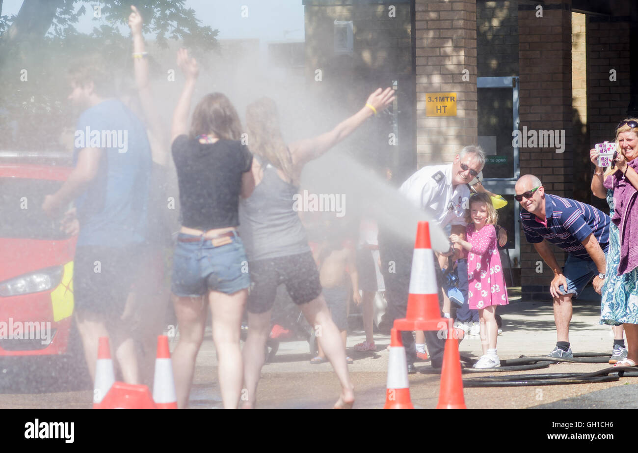 Market Deeping, Lincolnshire, UK. 7th August, 2016. What better way of cooling off then down at your local fire station, young girl uses the fireman hose to cool of friends. Credit:  Clifford Norton/Alamy Live News Stock Photo