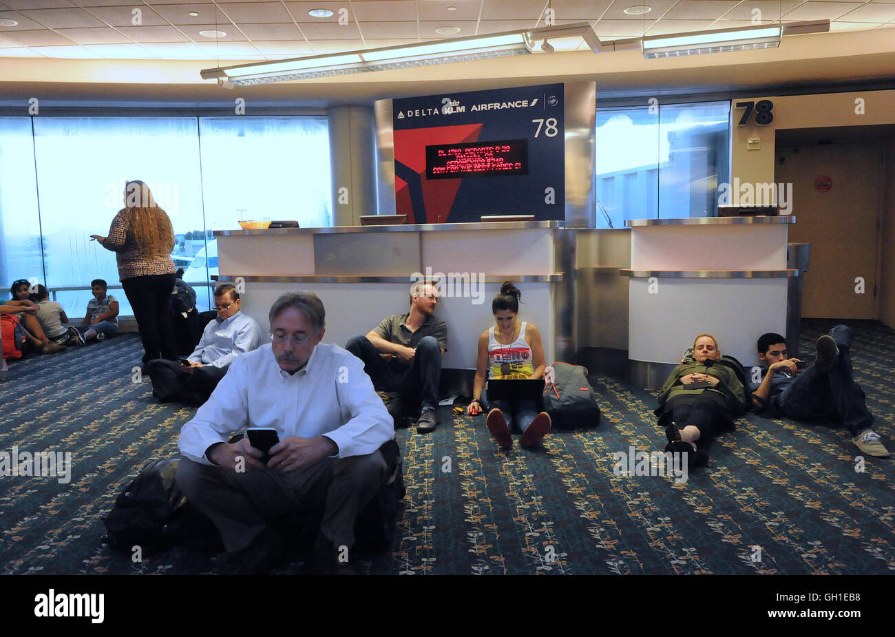 Orlando, Florida, USA. 8th August, 2016. Delta passengers wait on the floor at Orlando International Airport as all flights worldwide were grounded due to a computer system shutdown. Credit:  Paul Hennessy/Alamy Live News Stock Photo