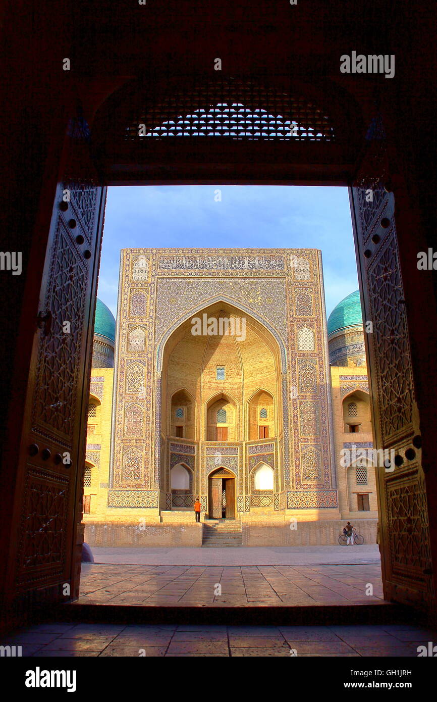 View of The Mir-i Arab Madrasa in Bukhara from the entrance of the Poy Kalon mosque in Bukhara, Uzbekistan Stock Photo