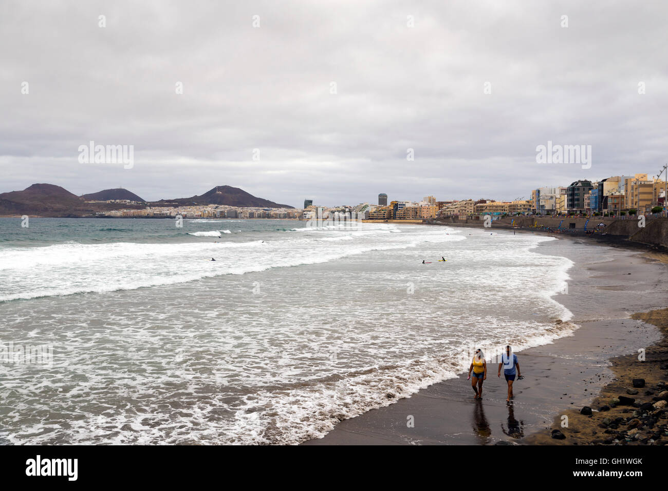 LAS PALMAS DE GRAN CANARIA, SPAIN - JULY 29, 2016: swimmers and surfers on the beach Las Canteras in Las Palmas, Canary Islands Stock Photo