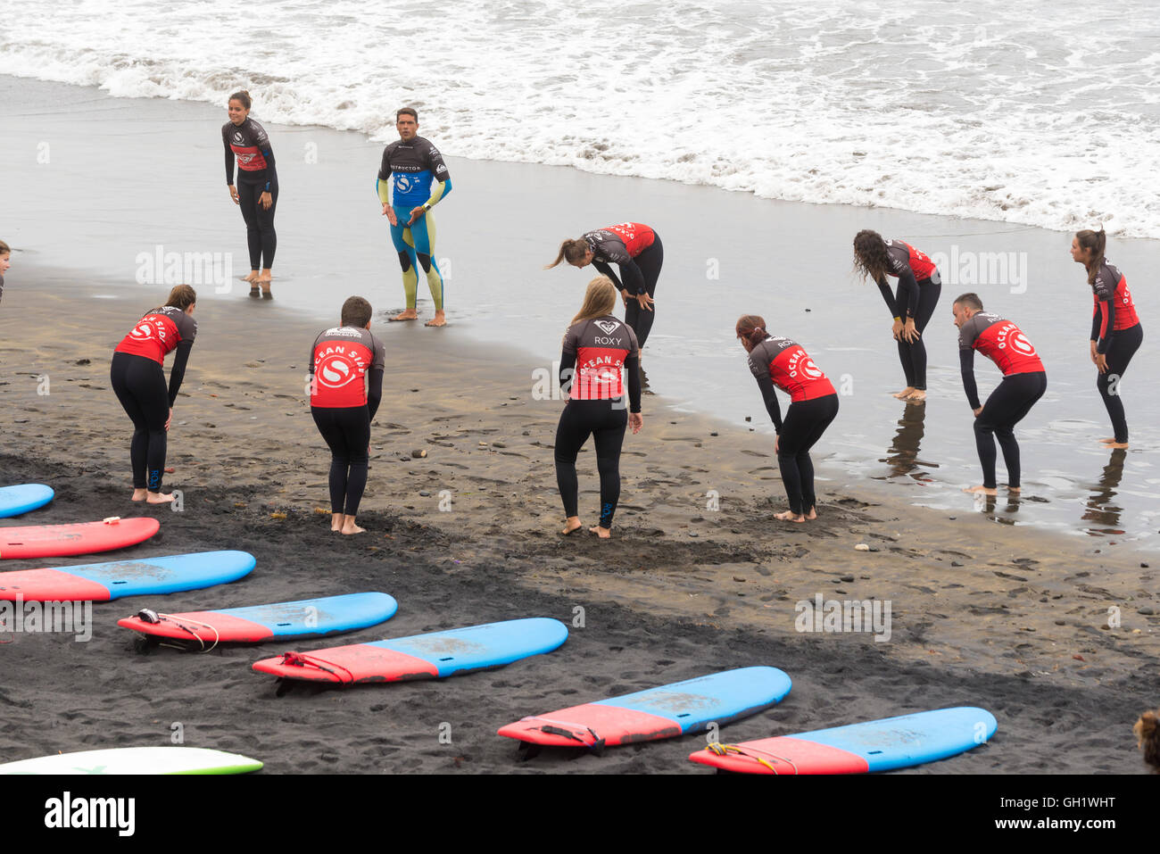 LAS PALMAS DE GRAN CANARIA, SPAIN - JULY 29, 2016: Class surfers on the beach Las Canteras, Las Palmas Stock Photo