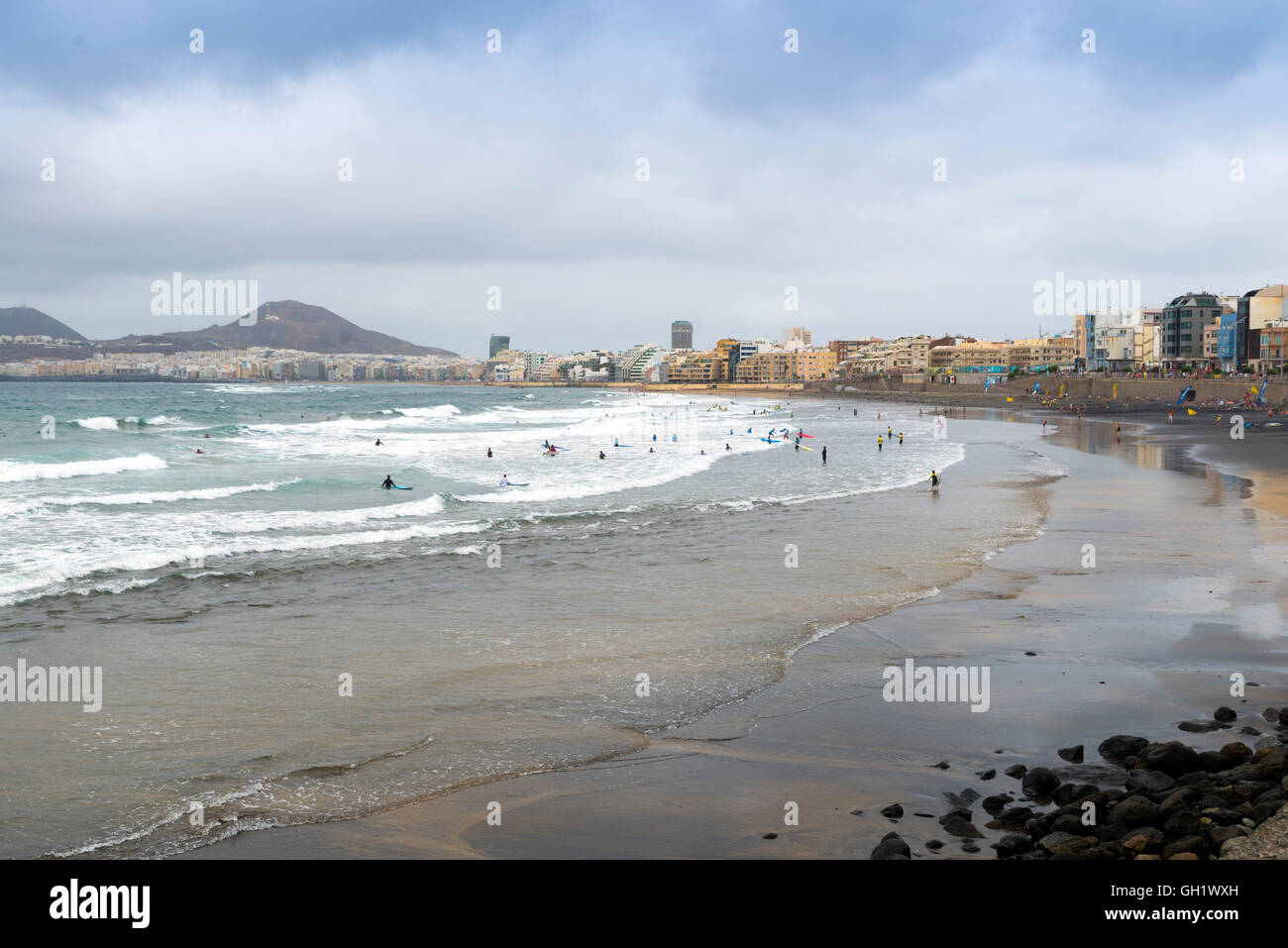 LAS PALMAS DE GRAN CANARIA, SPAIN - AUGUST 3, 2016: swimmers and surfers on the beach Las Canteras in Las Palmas, Canary Islands Stock Photo