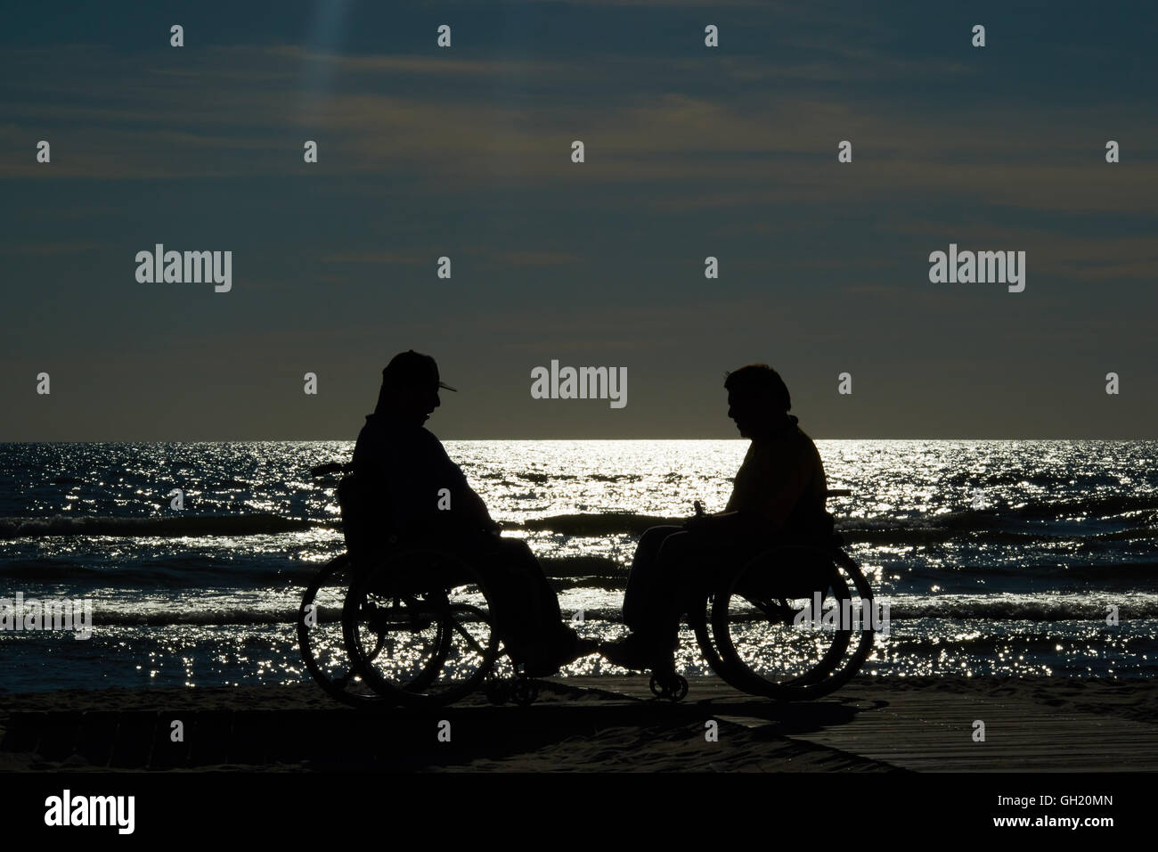 handicapped wheelchair by the sea at sunset Stock Photo - Alamy