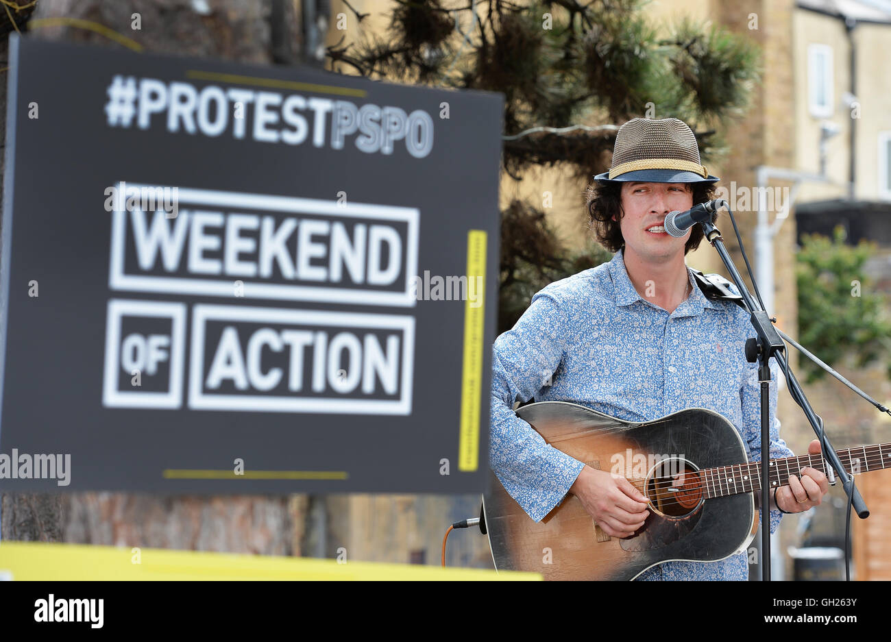 Jonny Walker sings during a protest against new local council Public Space Protection Orders (PSPO), in Gillett Square Dalston, London. Stock Photo