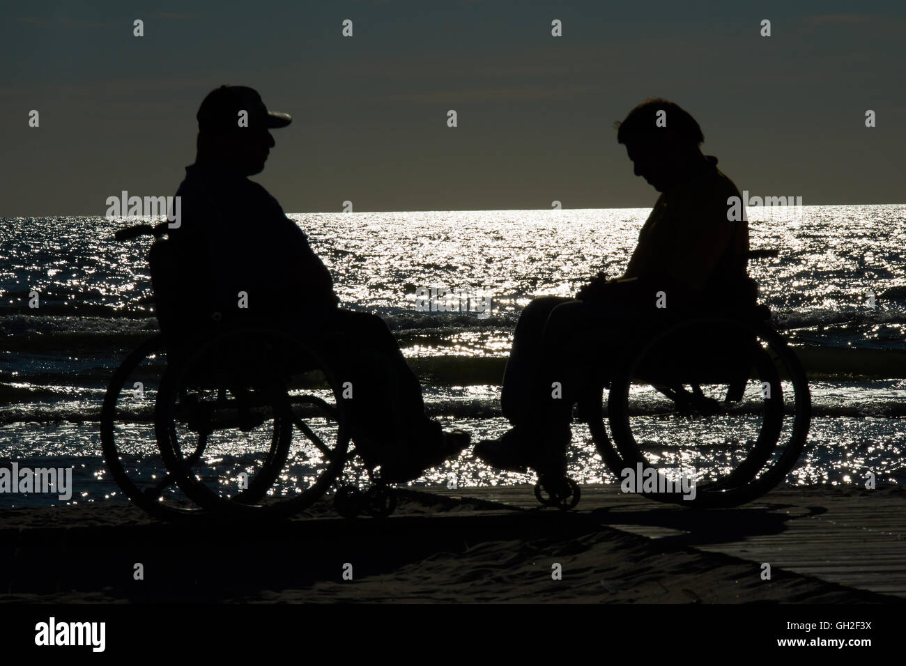 handicapped wheelchair by the sea at sunset Stock Photo - Alamy