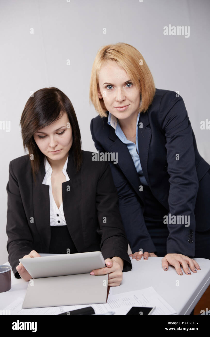 Two business woman in the office Stock Photo - Alamy