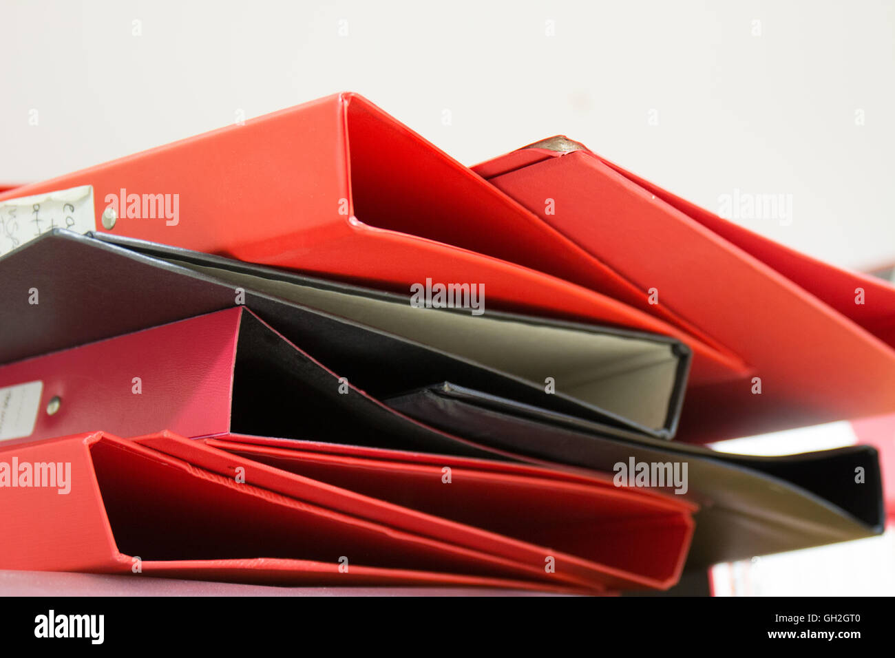 Messy pile of red & black ring binders Stock Photo Alamy