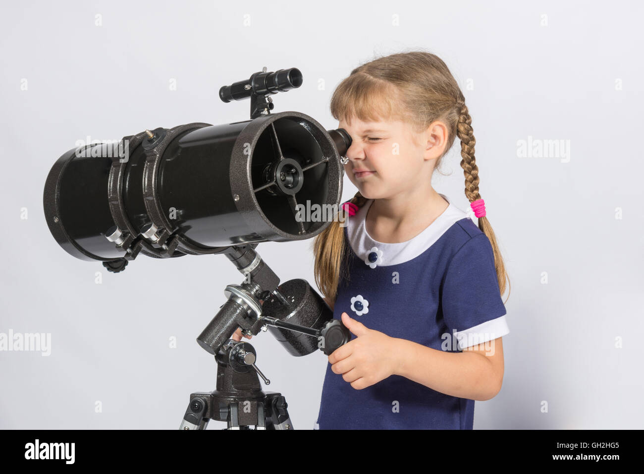Girl amateur astronomer sets up a telescope for observing the starry sky Stock Photo