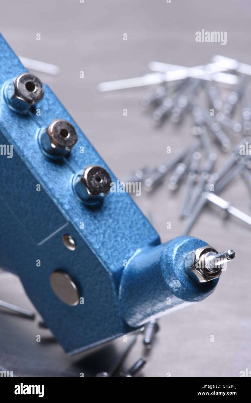Hand rivet tool on metal surface Stock Photo