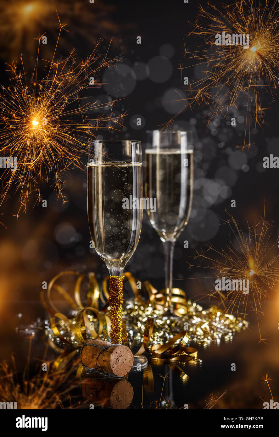 Champagne glasses on festive sparkler background Stock Photo