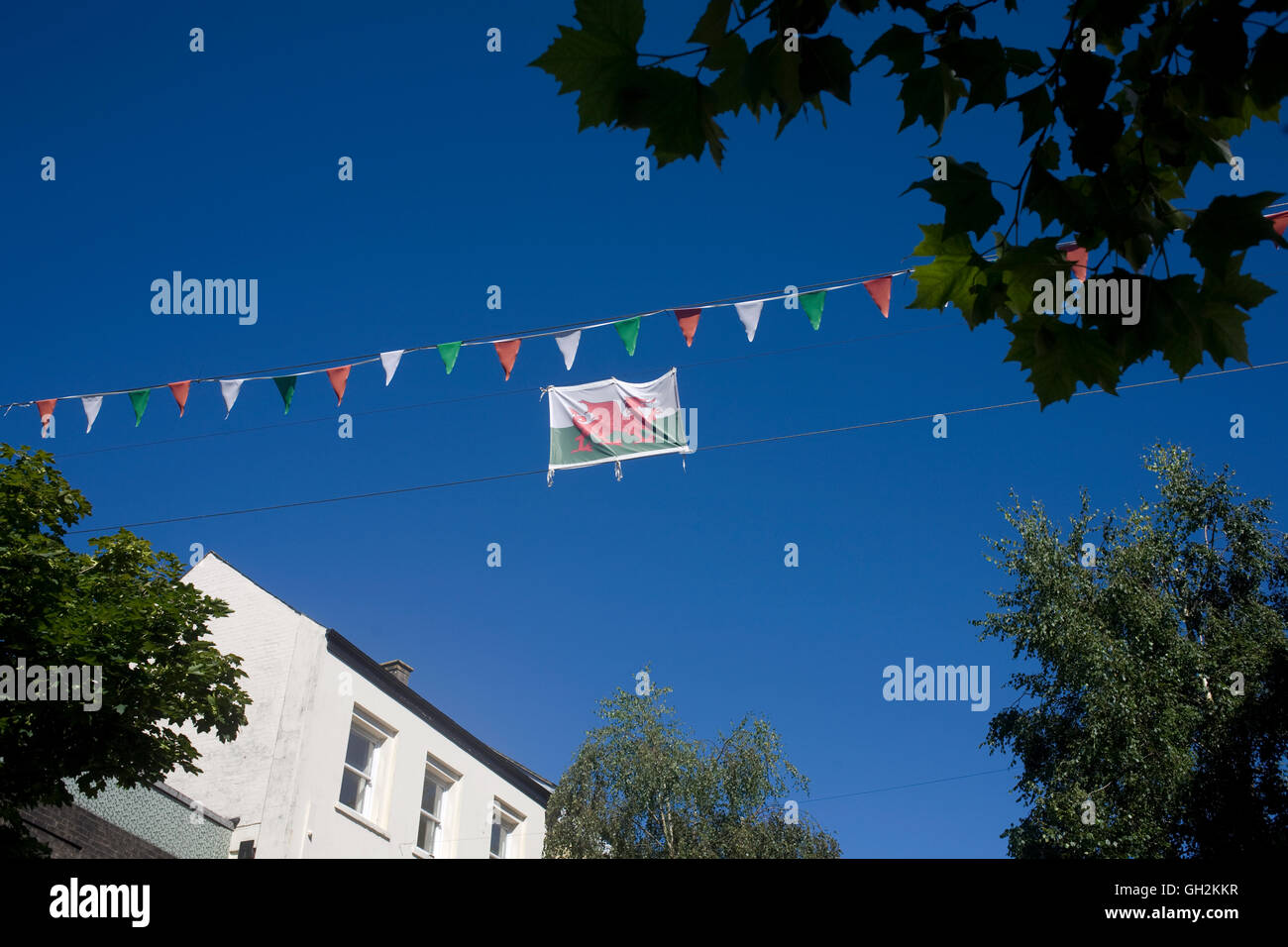 Welsh flag held high above square in Carmarthen town centre Stock Photo