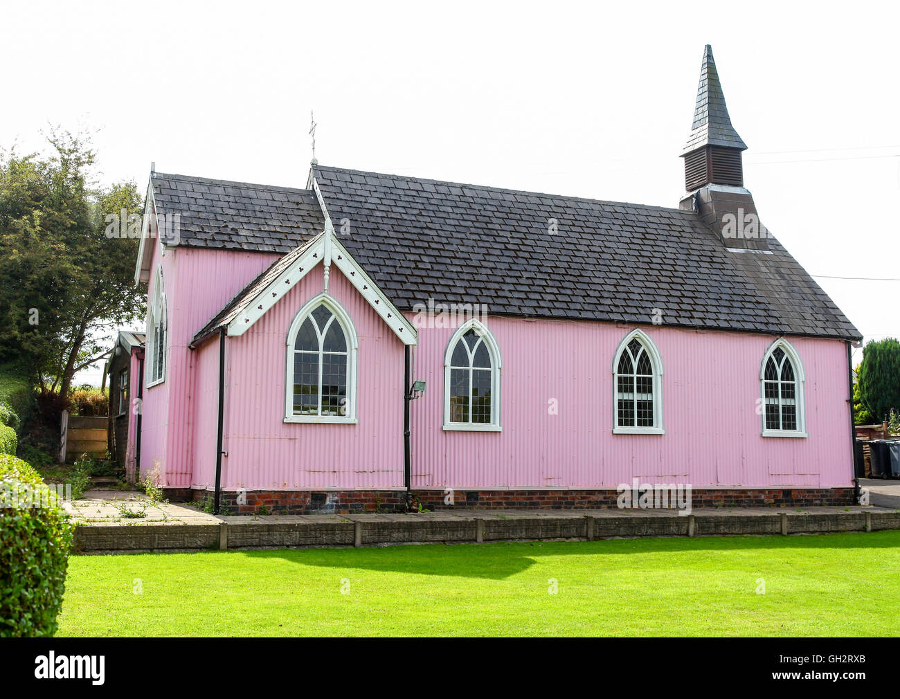 The pink painted corrugated iron clad tin tabernacle, St. Philip's church Hassall Green Cheshire England UK Stock Photo