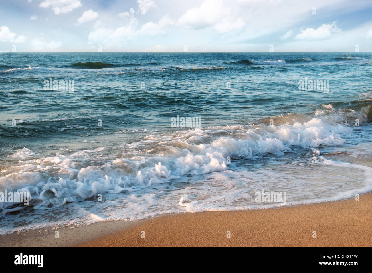 sandy beach, beautiful ocean waves and sky Stock Photo - Alamy