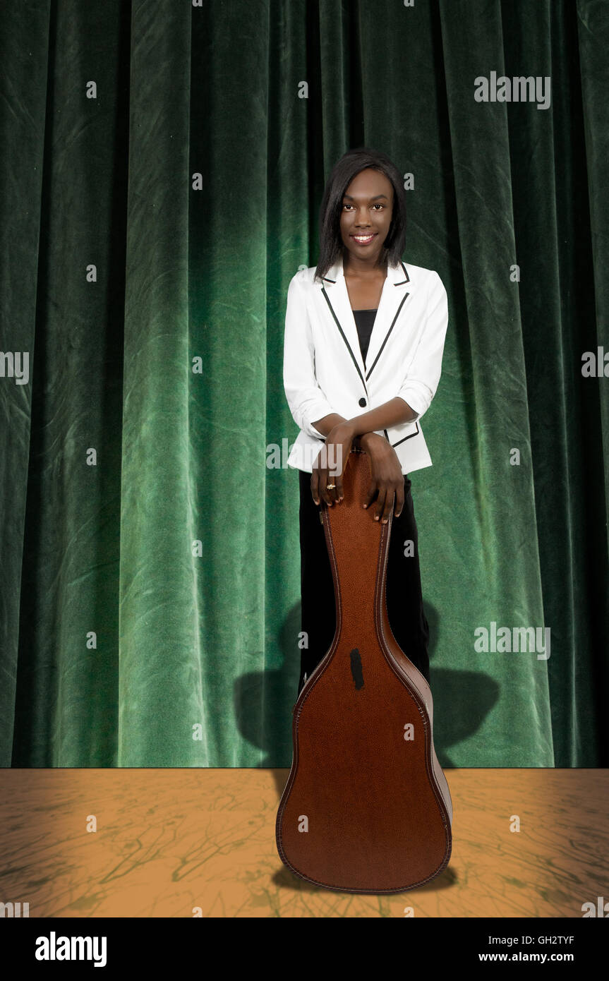 Beautiful young woman with a acoustic guitar case Stock Photo - Alamy