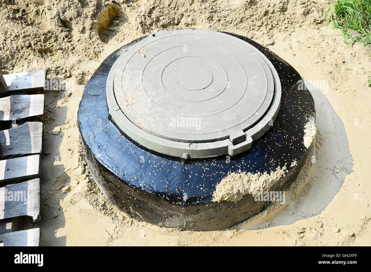 New cesspit closed the hatch at the construction site. Stock Photo