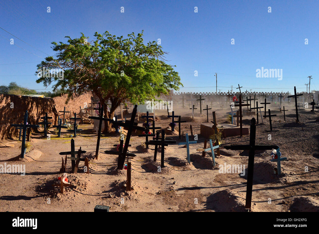 Sand and dust blows through the cemetery of San Pedro de Atacama in northern Chile. Stock Photo