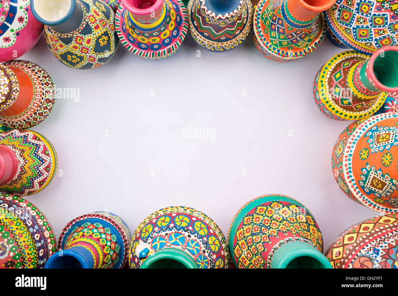 Frame of painted colorful pottery vases on white background Stock Photo