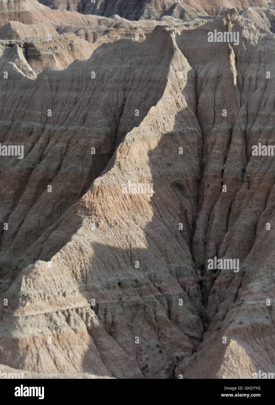 Erosion has shaped a sandstone ridge line into a gentle sweeping curve. Stock Photo