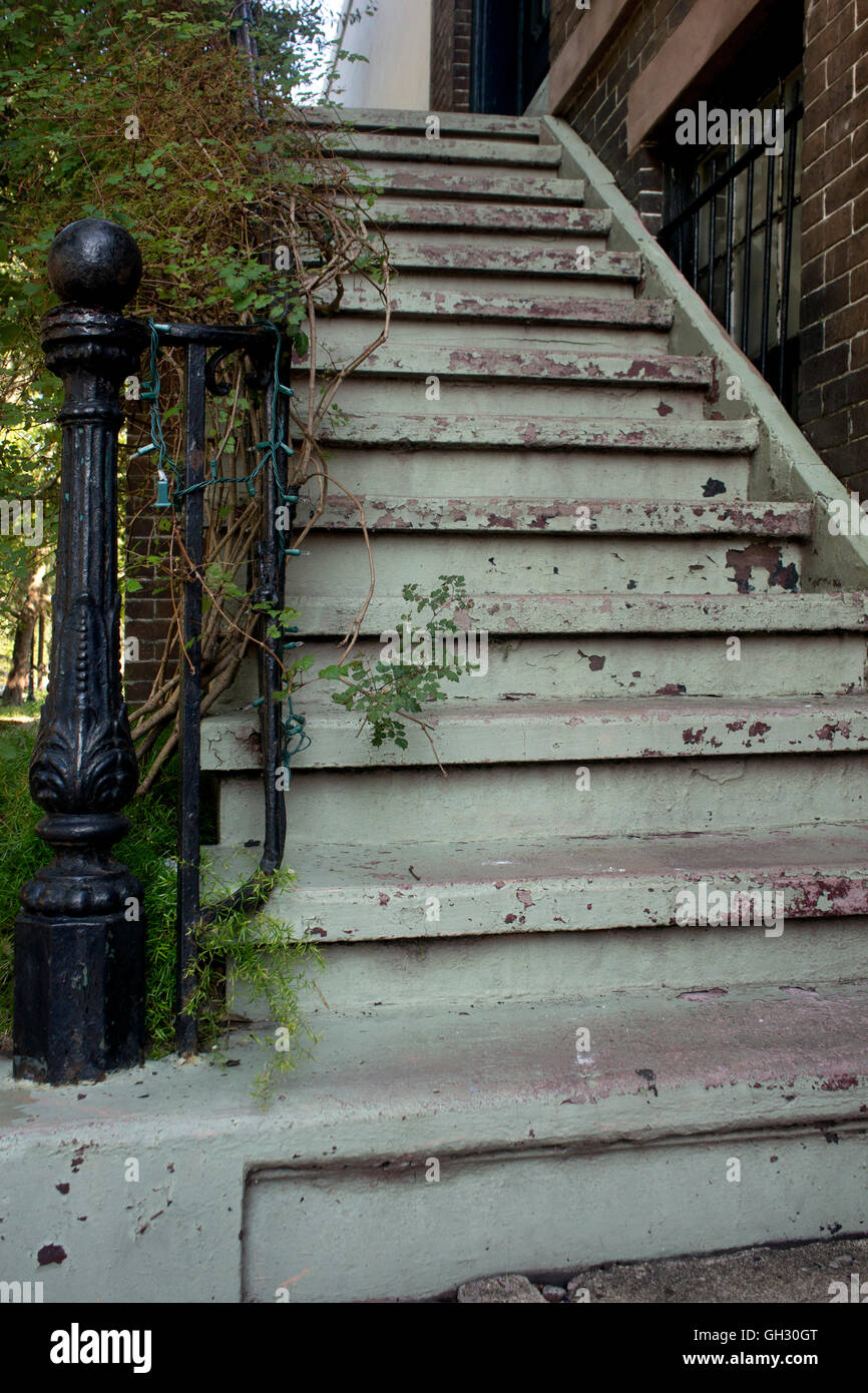 Old Savannah staircase with iron newel post & patina of peeling paint. Stock Photo