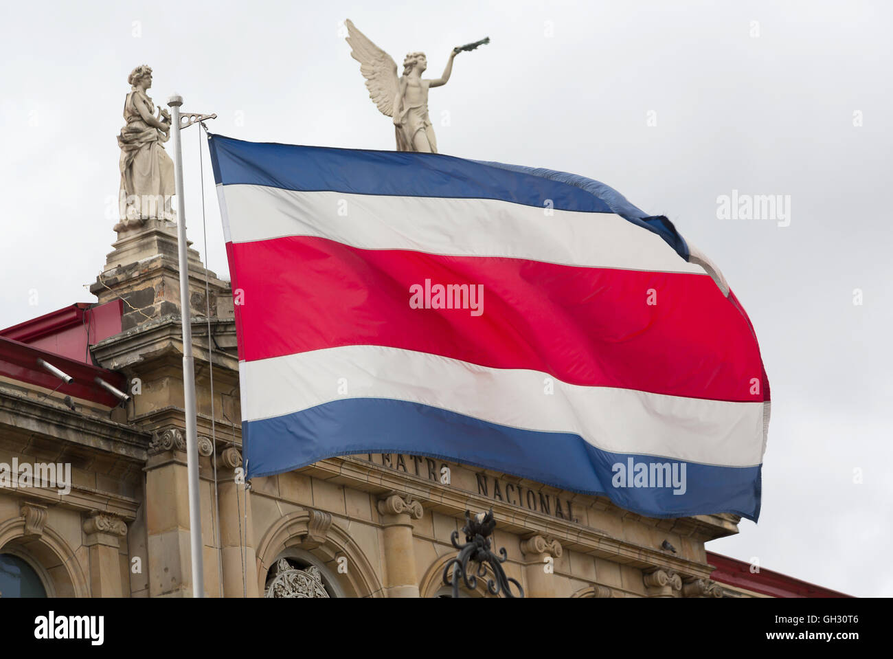 View of the Costa Rican flag in the background of the National Theater (focus on flag) Stock Photo