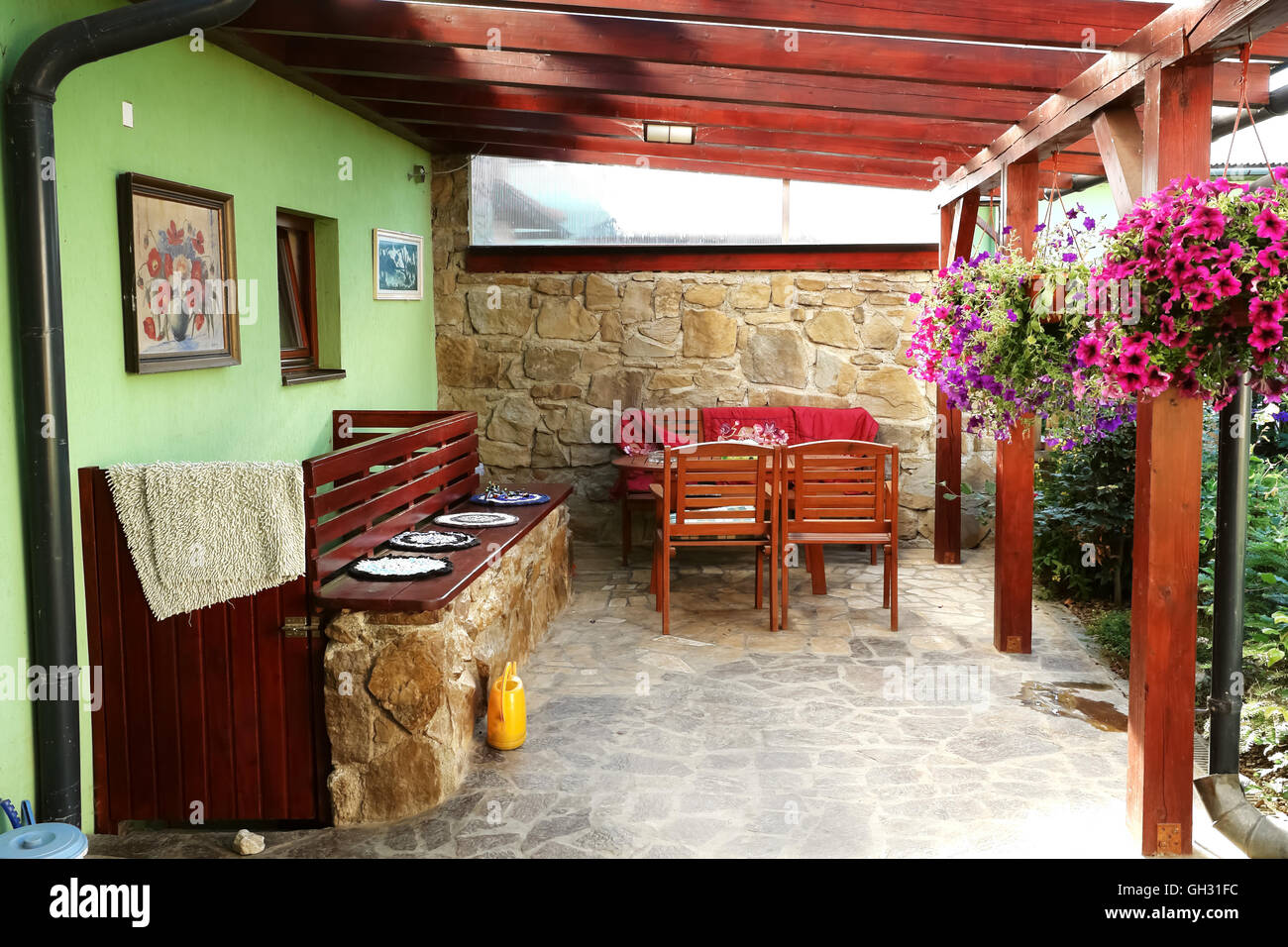 Lubica, PRESOV, SLOVAKIA - JULY 07, 2016: The small area of  yard with chairs, tables and flowers in slovakian house in Lubica Stock Photo