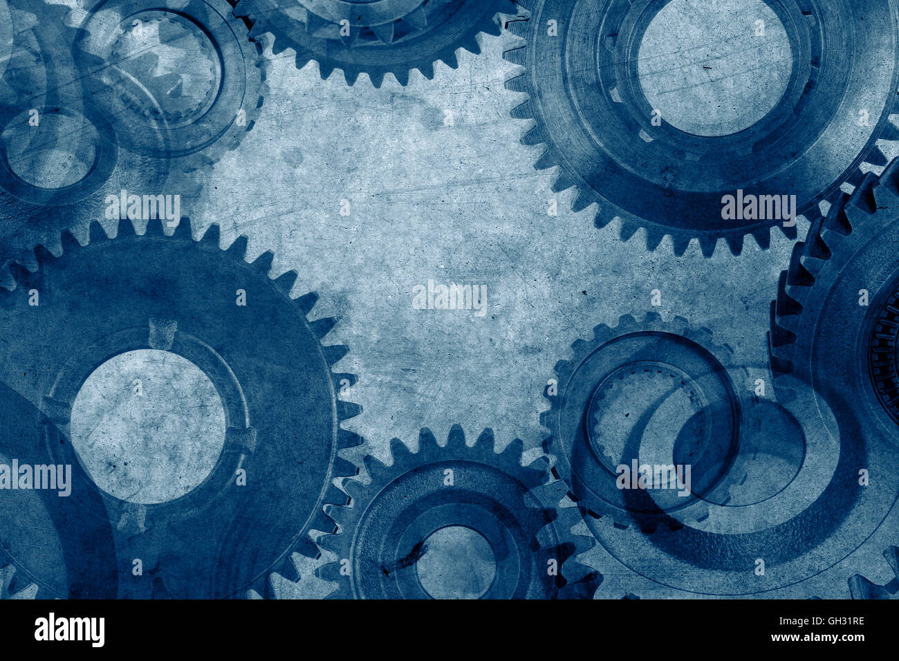 Metal gears on blue background Stock Photo - Alamy