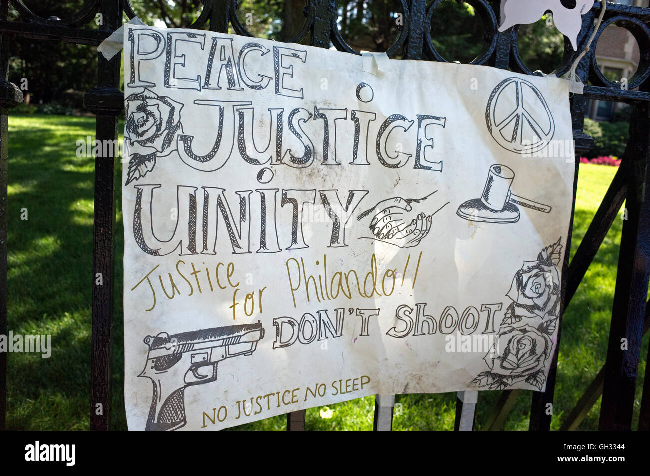 Peace Justice Unity poster on governor's fence honoring the unfortunate
