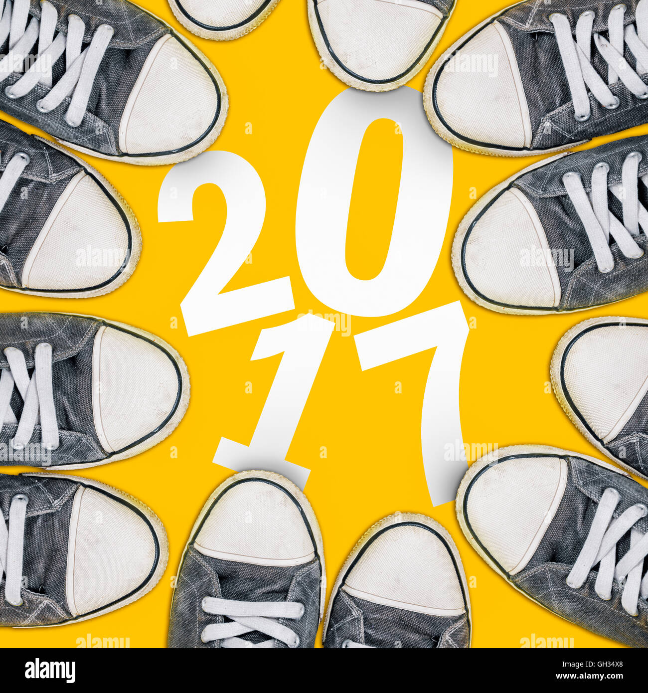 Happy new year concept, young people wearing sneakers from above surrounding number 2017 Stock Photo