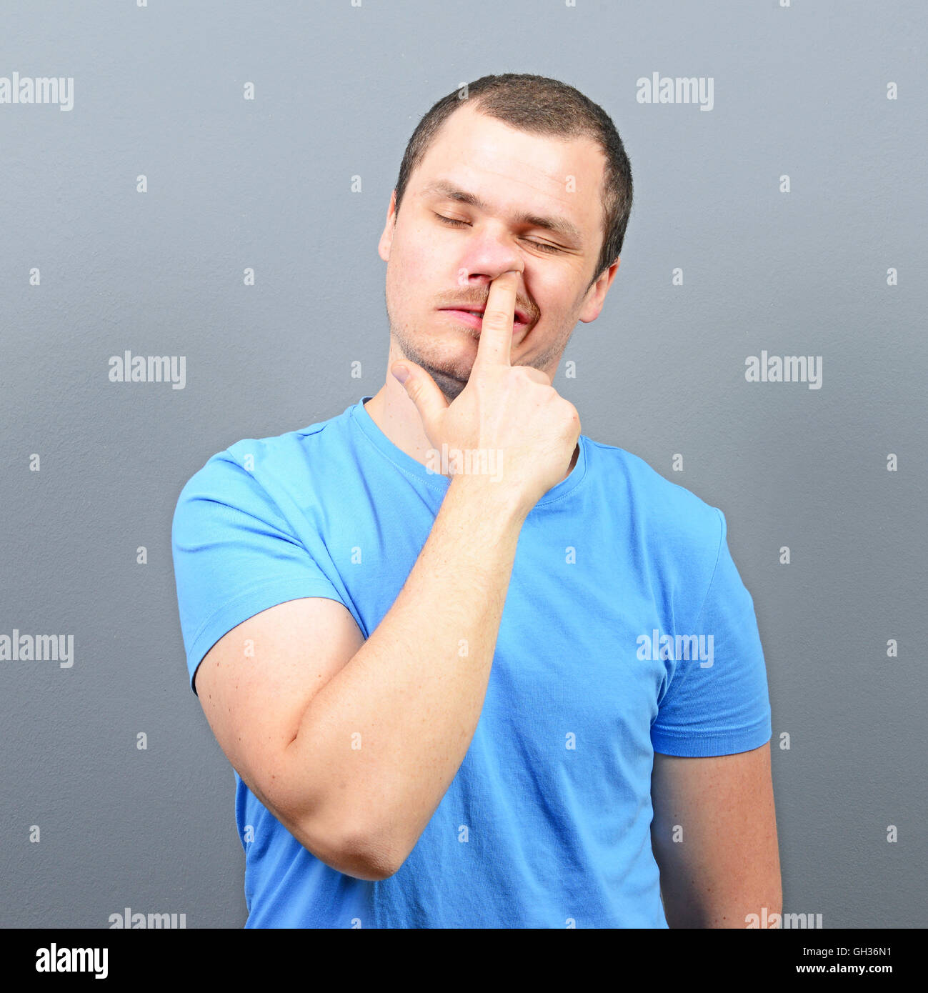 Man putting finger deep in his nose - Bad habit concept Stock Photo